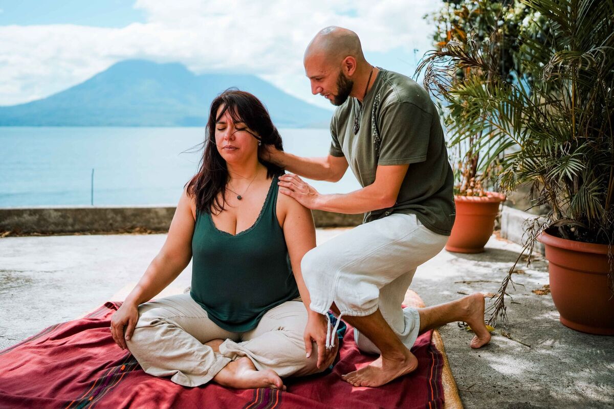 Nico offering guiding touch during a one-on-one breathwork session