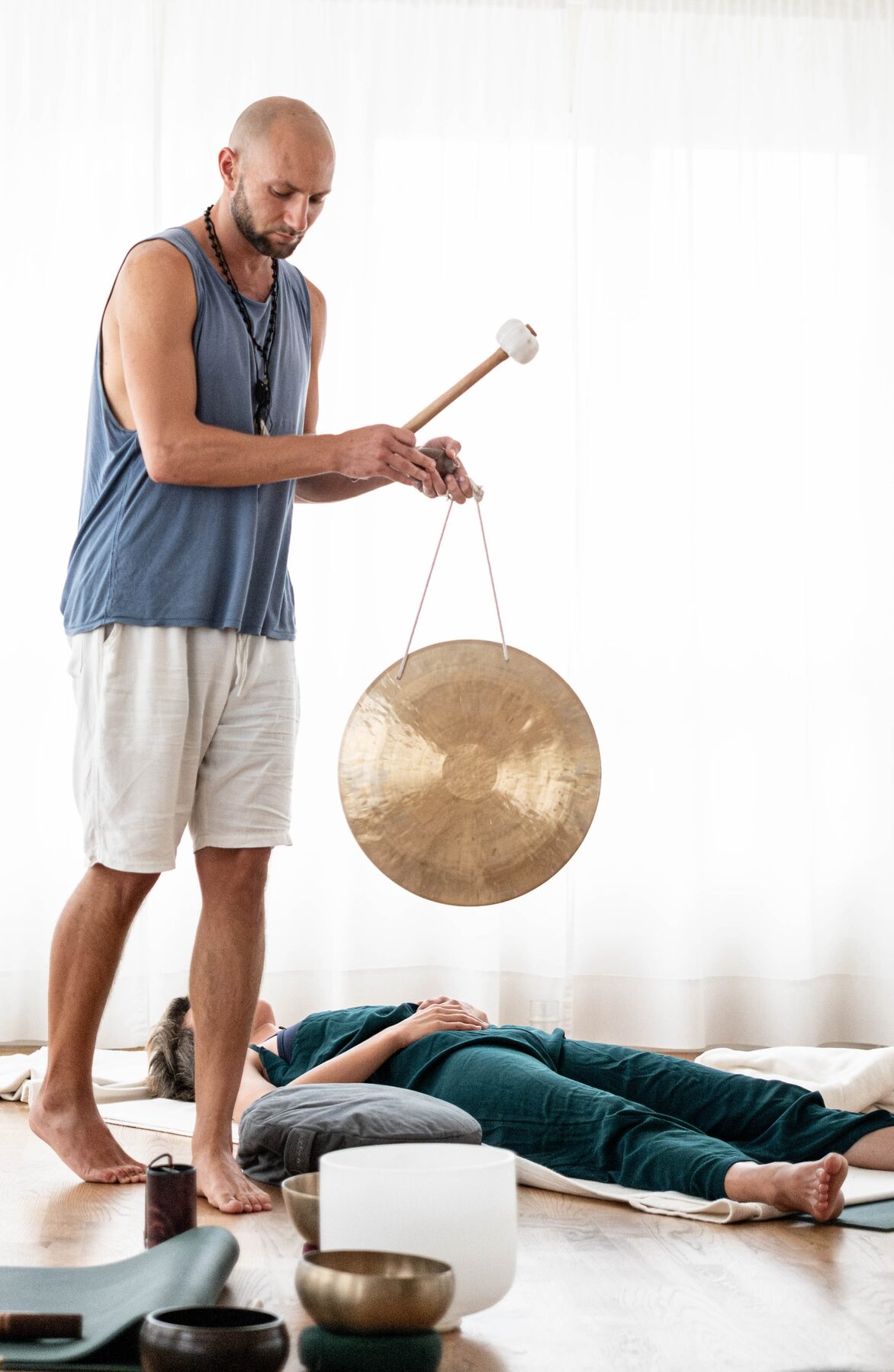 Nico playing a gong during a sound and breathwork session