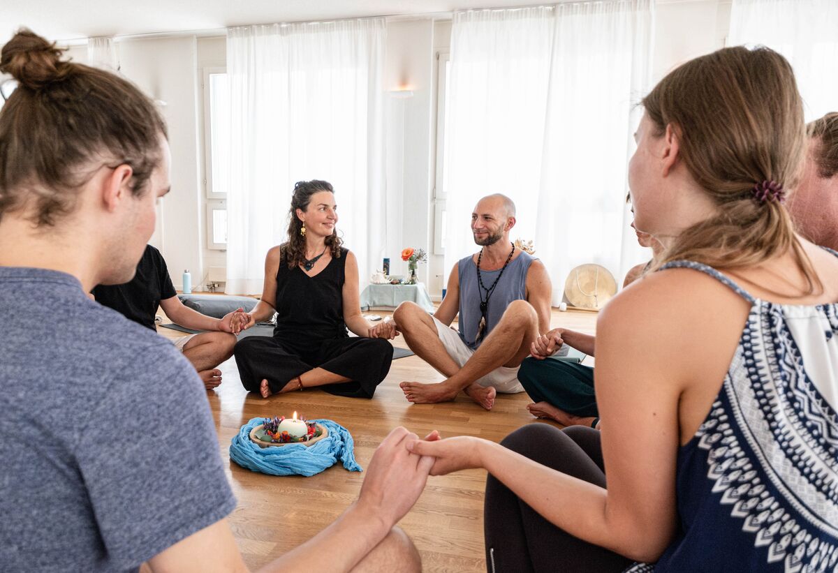 A small group sitting together after a shared breathwork experience